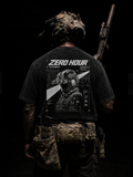Person wearing a black t-shirt with 'Zero Hour' design and holding a rifle on a dark background