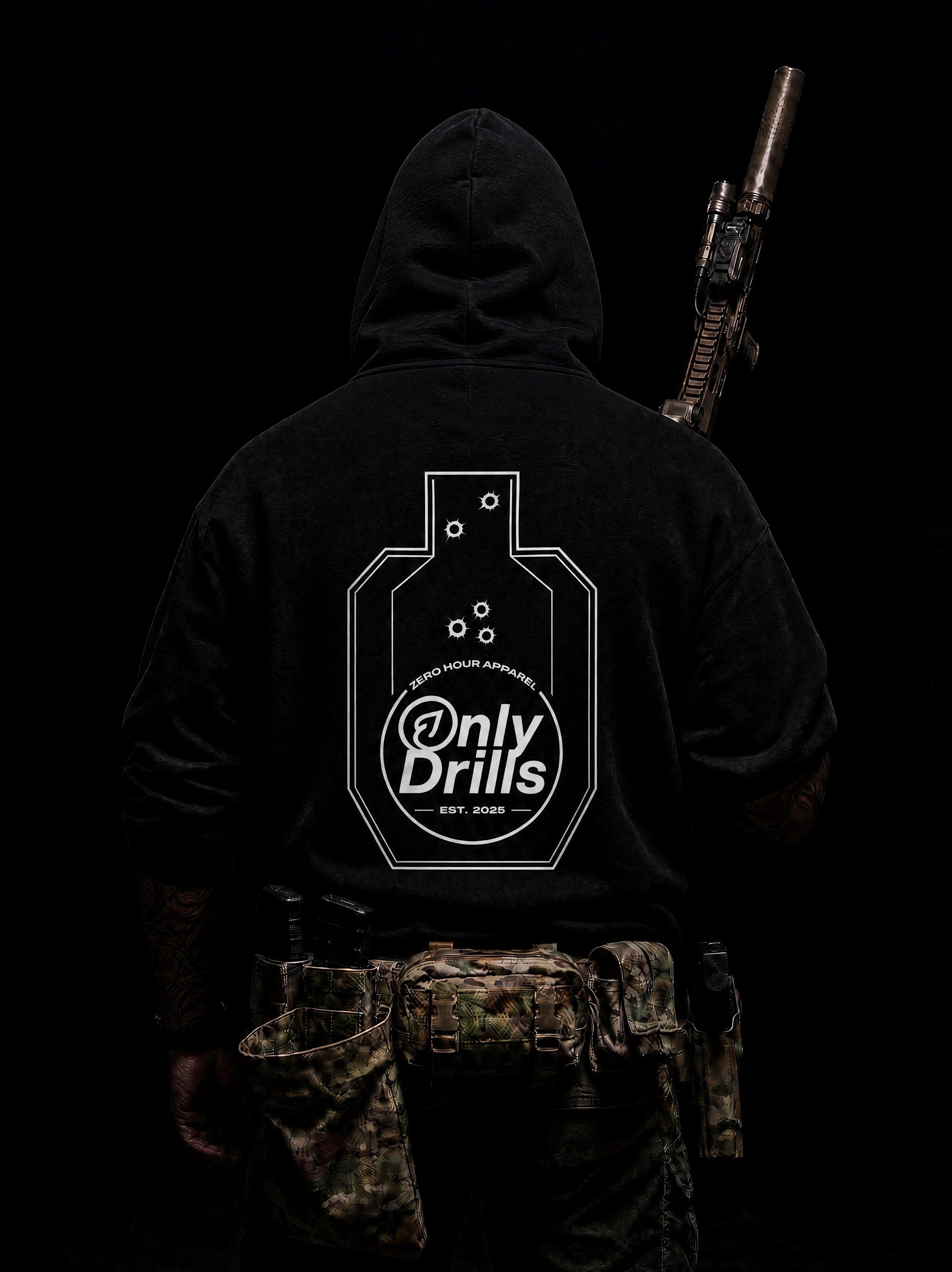 Person wearing a black hoodie with 'Only Drills' logo and holding a rifle on a dark background