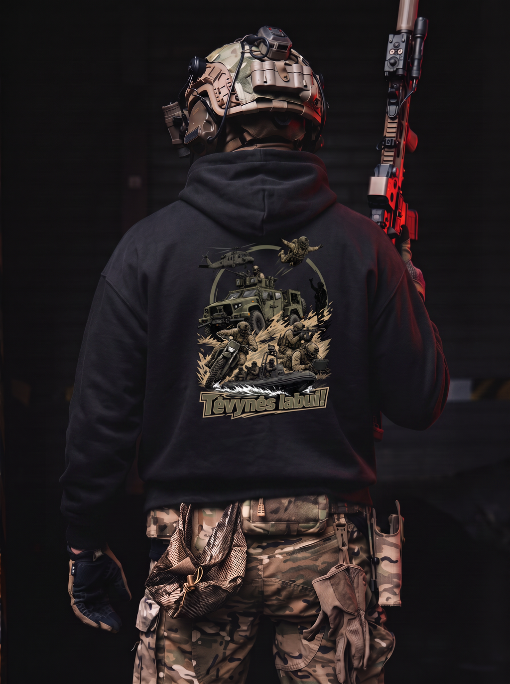 A person shown from behind wearing a black hoodie with a large tactical graphic print on the back, paired with camouflage cargo pants and a tactical helmet, holding a red and black rifle against a dark background.