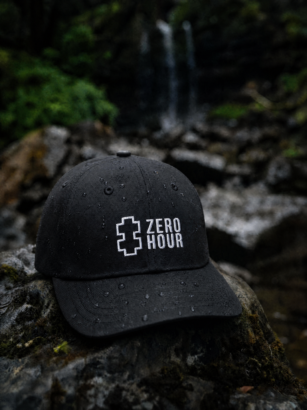 Black cap with 'Zero Hour' logo on a rock with a natural background