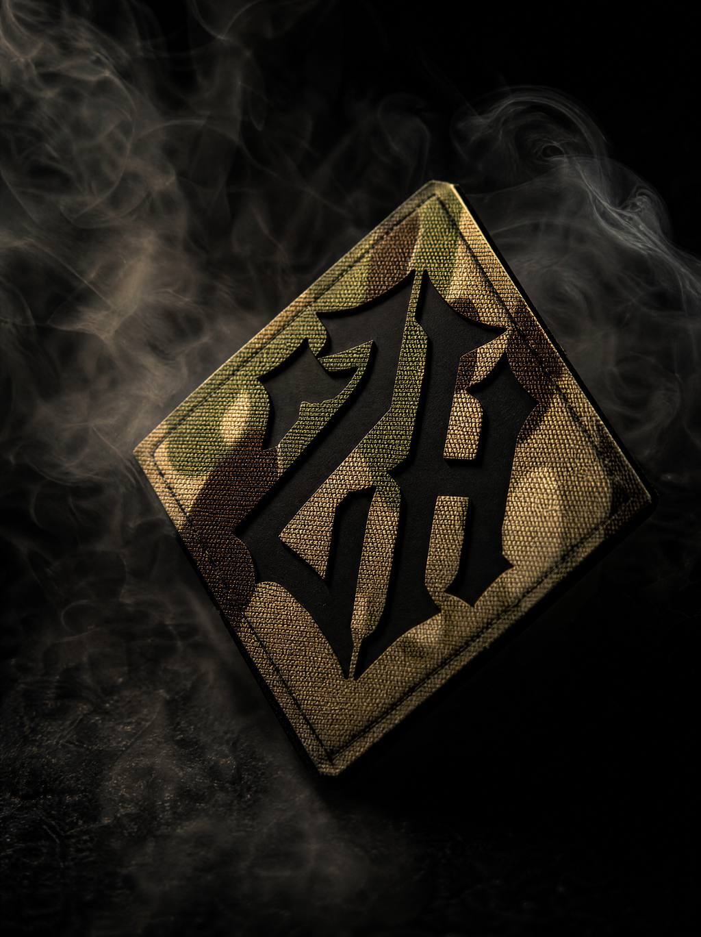 A diamond-shaped tactical patch with a black gothic letters 'ZH' over a camouflage pattern, set against a dark background with dramatic smoke effects.