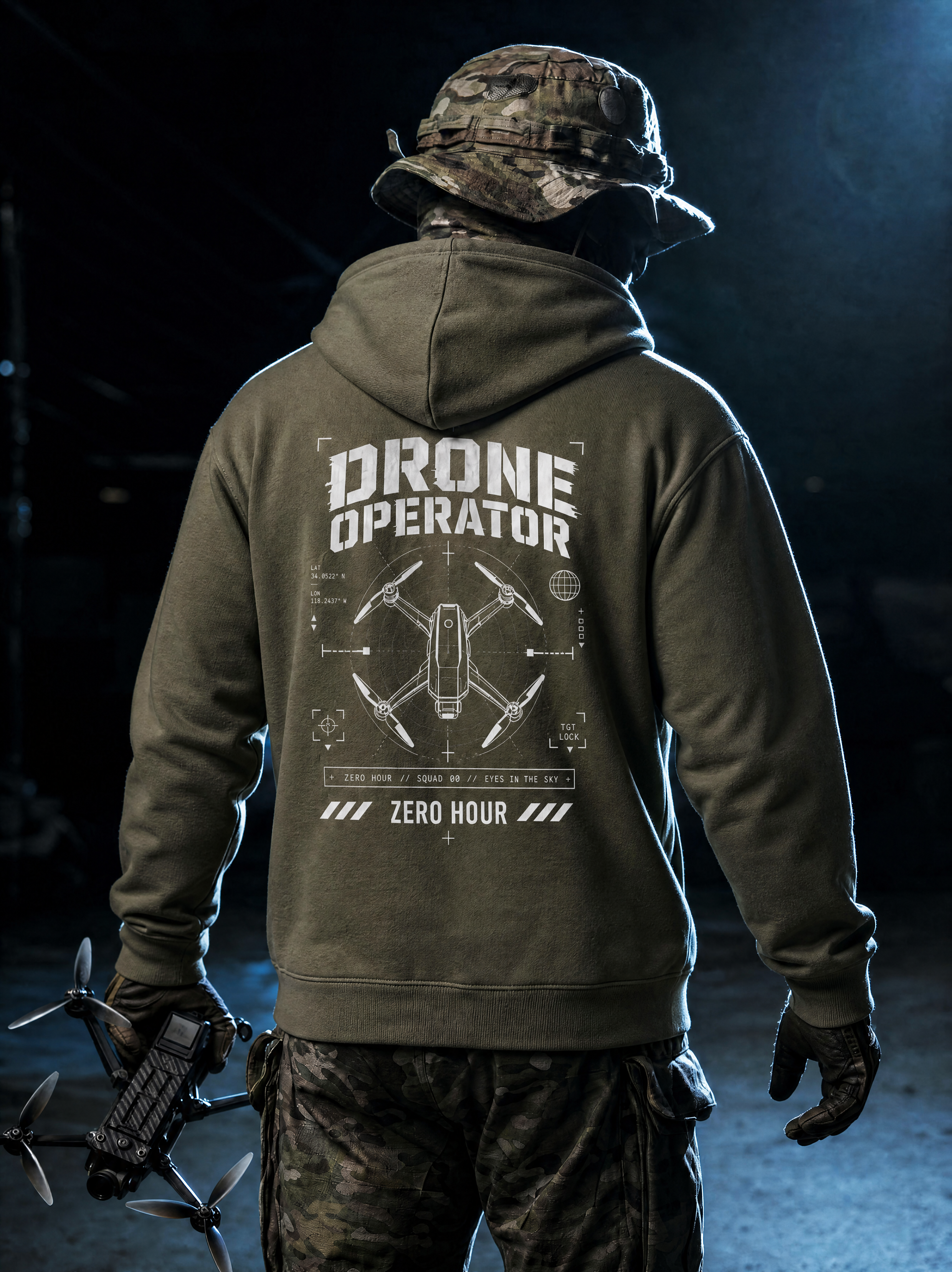 Person wearing a hoodie with 'Drone Operator' text and drone graphic, holding a drone in a dark setting.