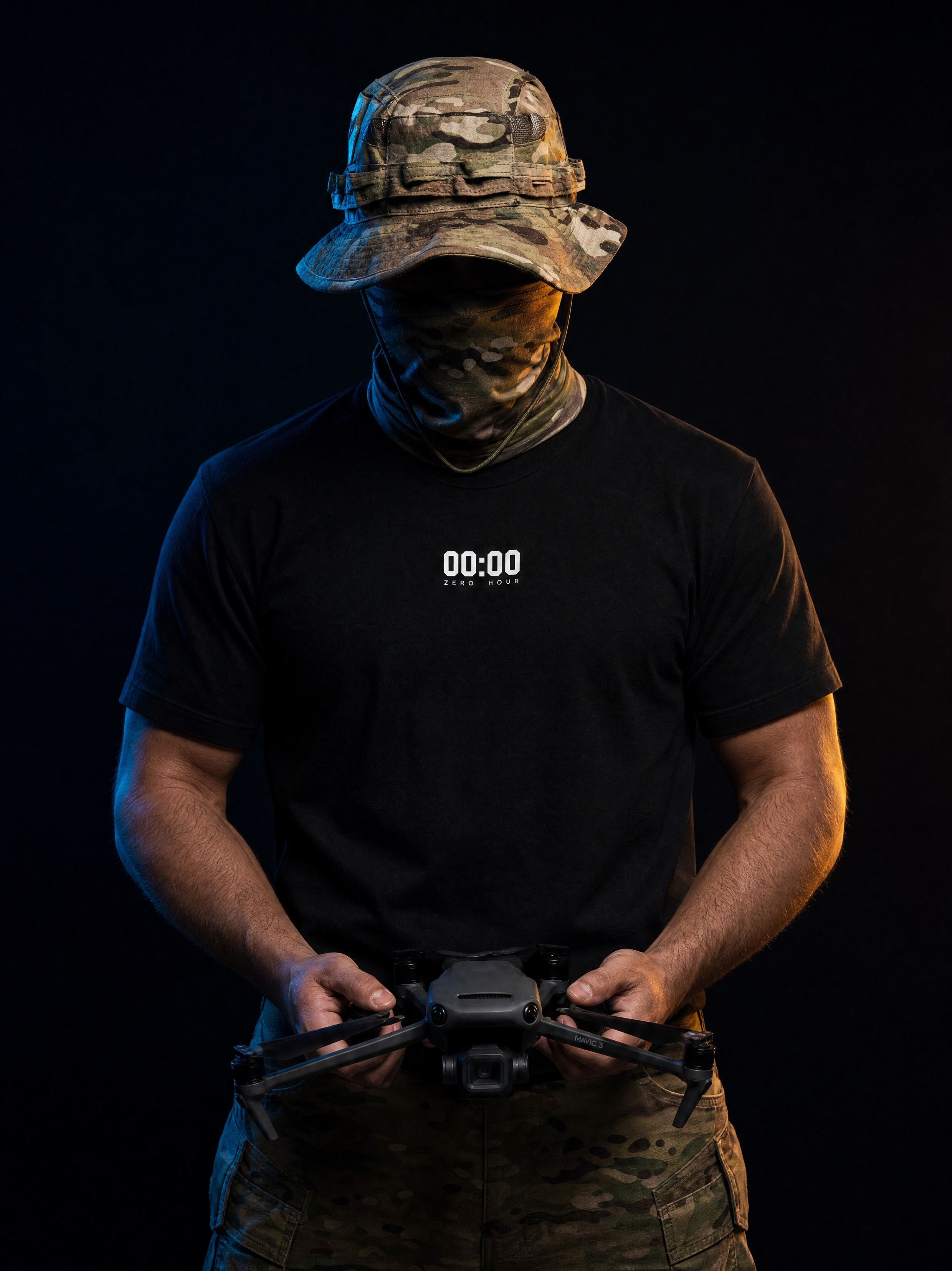 Person in tactical gear holding a device with a timer display on a black background