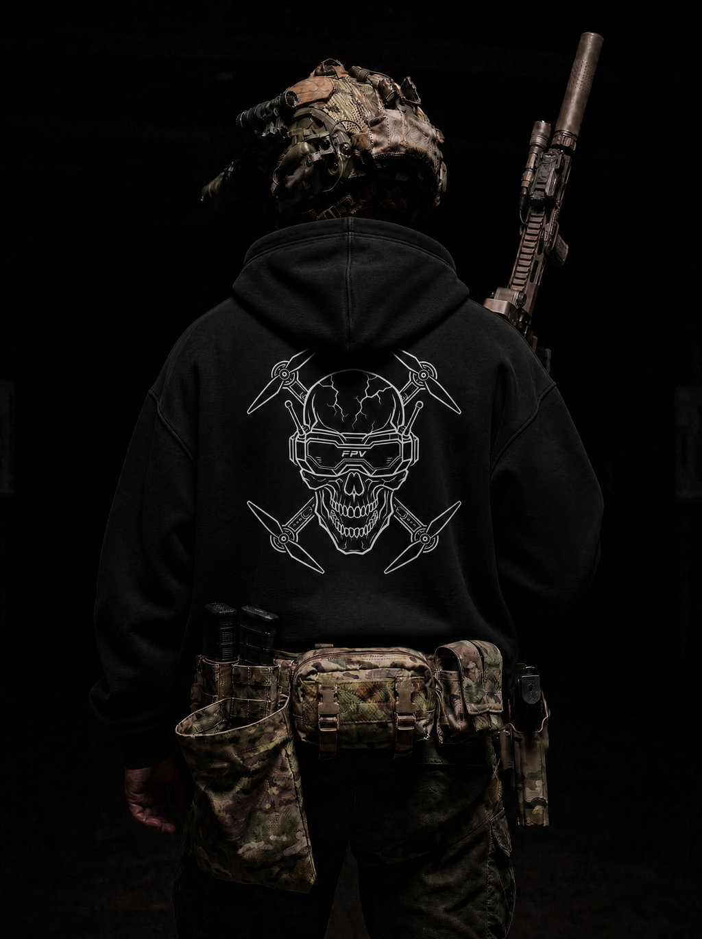 Person wearing a black hoodie with a skull design, camouflage helmet, and tactical belt on a dark background