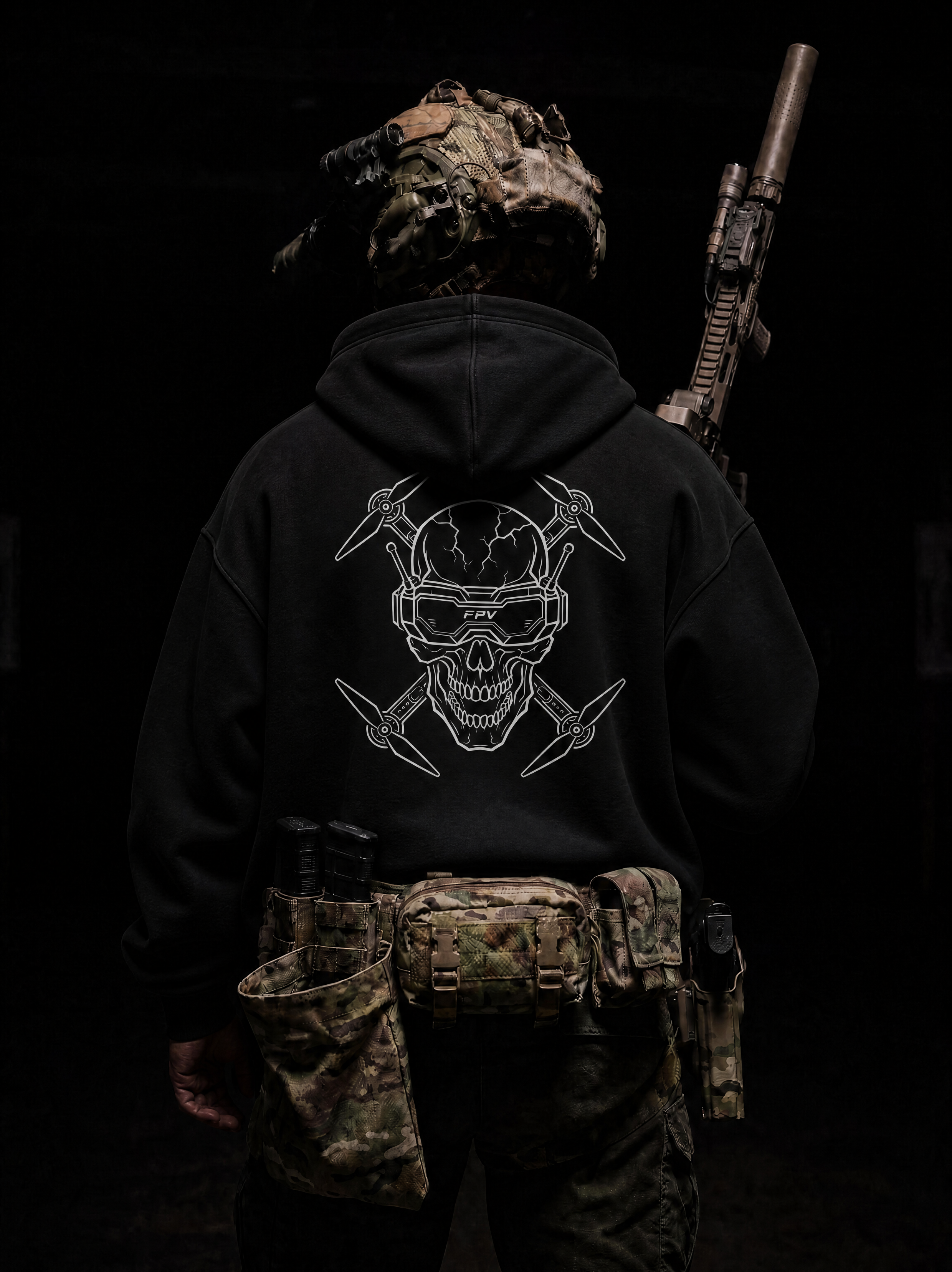 Person wearing a black hoodie with a skull design, camouflage helmet, and tactical belt on a dark background