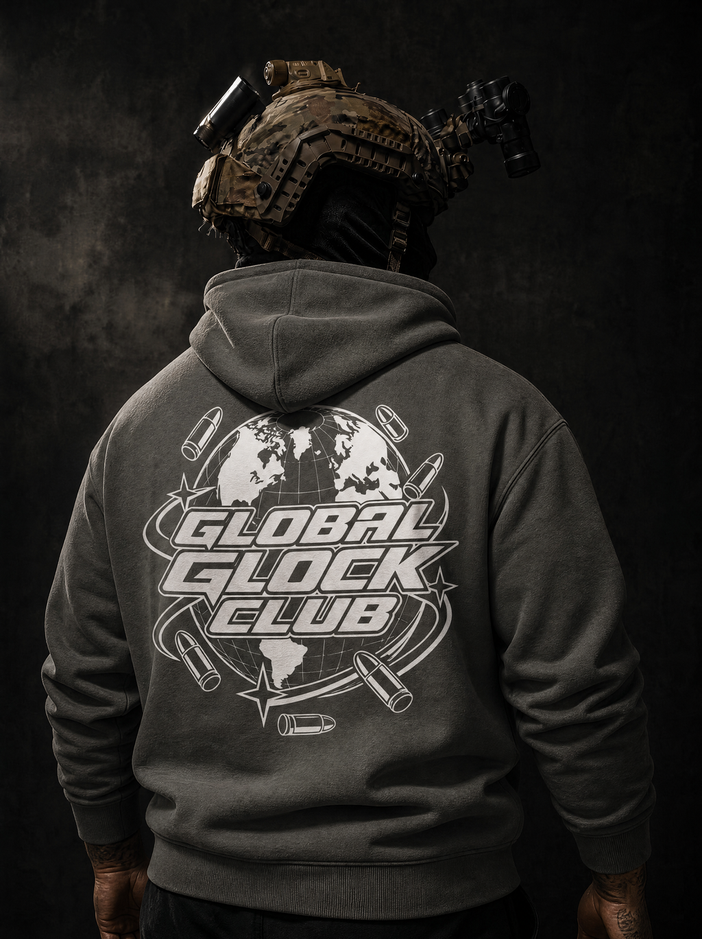 A person shown from the back wearing a dark gray hoodie with a large white 'GLOBAL GLOCK CLUB' graphic printed on the back, including a globe and bullet motifs. The person is also wearing a tactical helmet with mounted lights against a dark textured background.