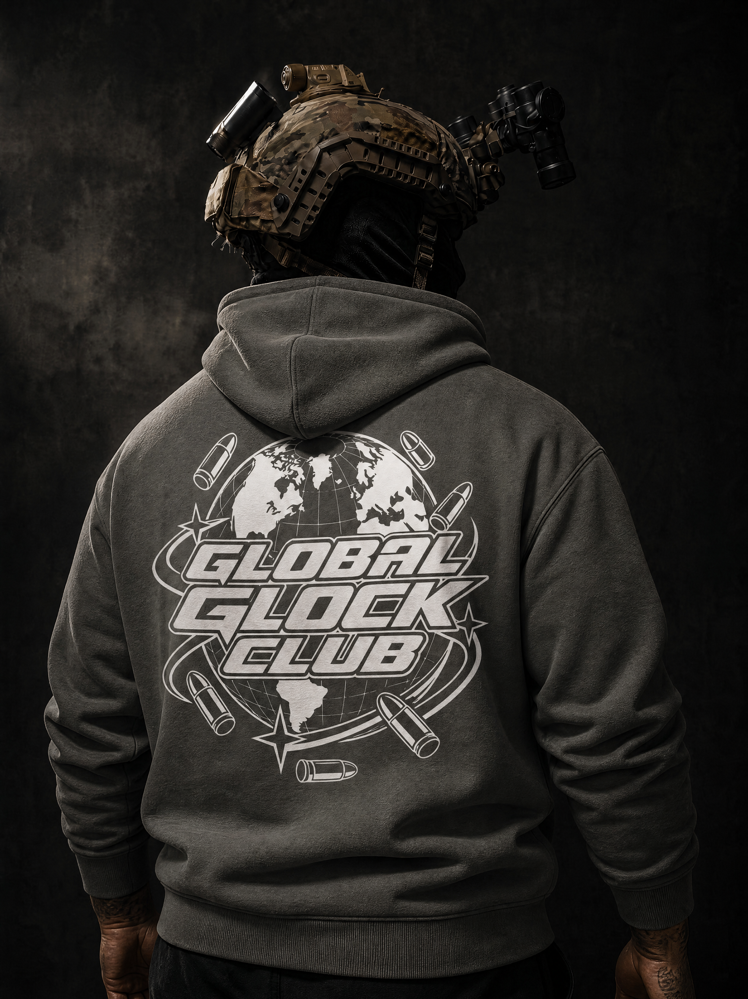A person shown from the back wearing a dark gray hoodie with a large white 'GLOBAL GLOCK CLUB' graphic printed on the back, including a globe and bullet motifs. The person is also wearing a tactical helmet with mounted lights against a dark textured background.