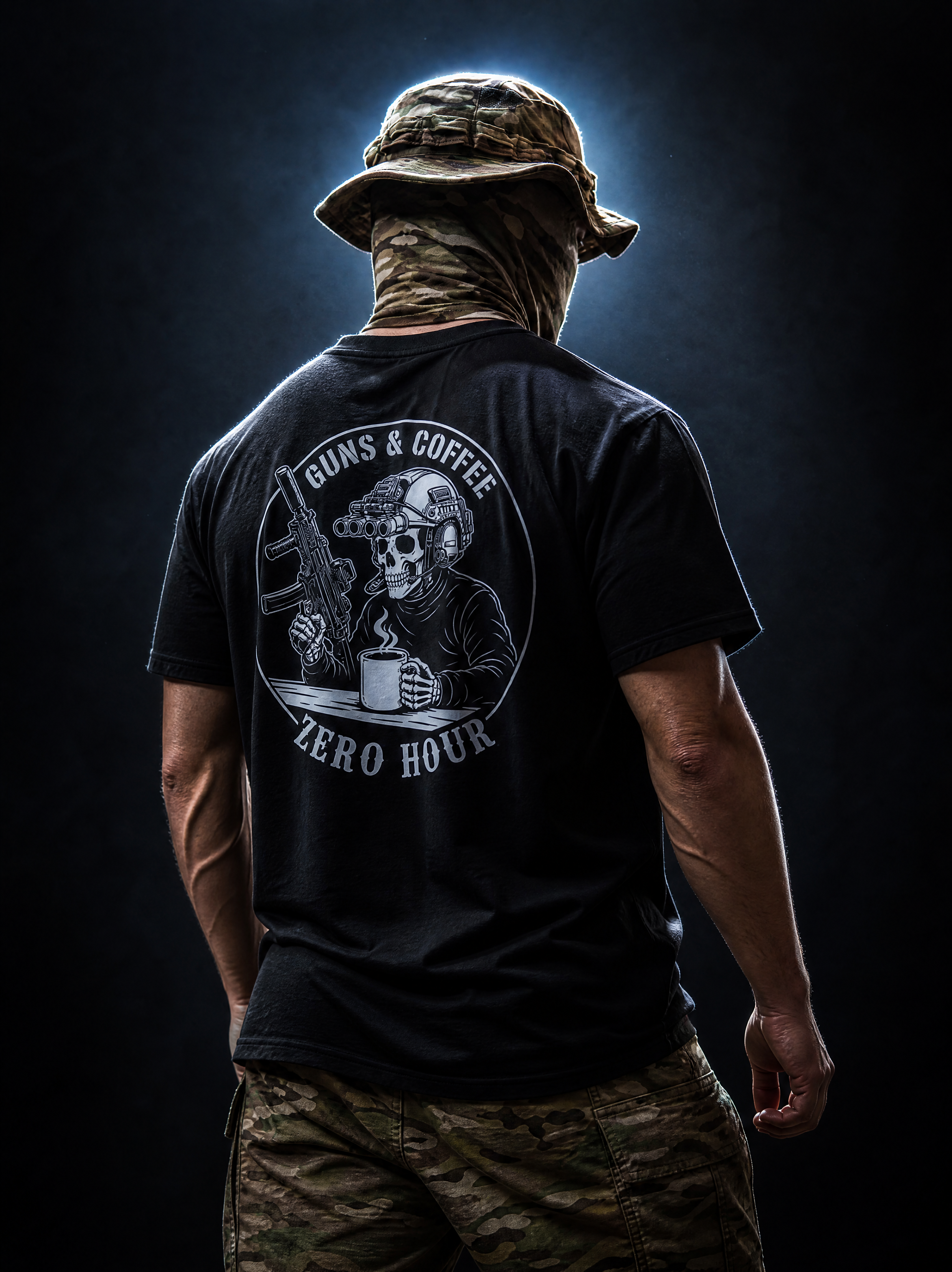 Person wearing a black t-shirt with a graphic design and text, standing against a dark background.