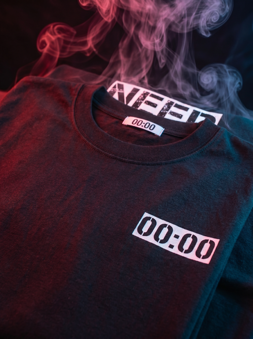 Black t-shirt with '00:00' text, surrounded by colorful smoke.