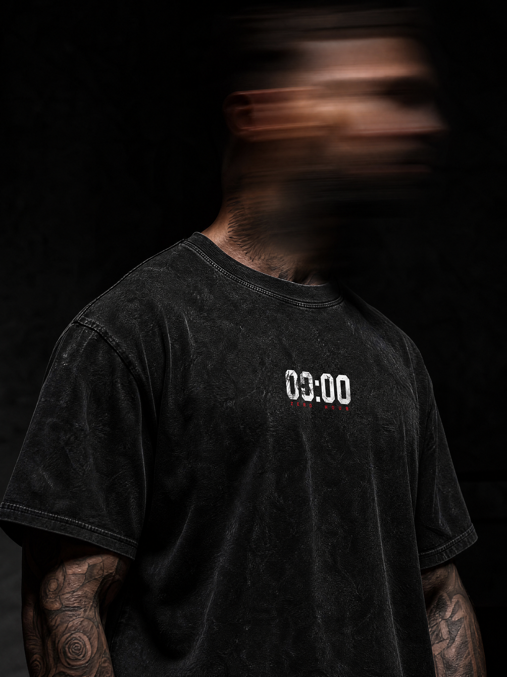 Person wearing a black t-shirt with '00:00' on a dark background