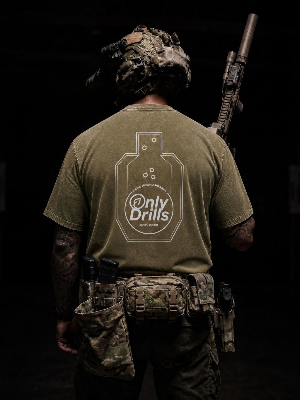 Person wearing a green t-shirt with 'Only Drills' logo, holding a rifle on a dark background