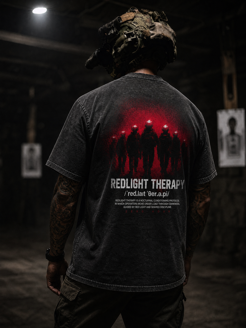 Person wearing a t-shirt with 'Redlight Therapy' design in a dark setting