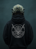 Person wearing a black hoodie with a white graphic design on the back, against a dark background.