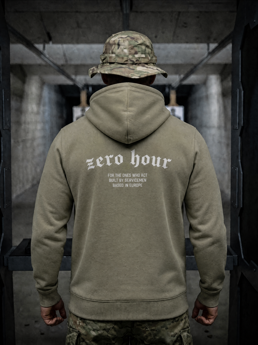 Person wearing a green hoodie with 'zero hour' text in an urban setting